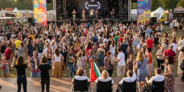 Diverse crowd celebrating at an inclusive American festival with accessibility features.